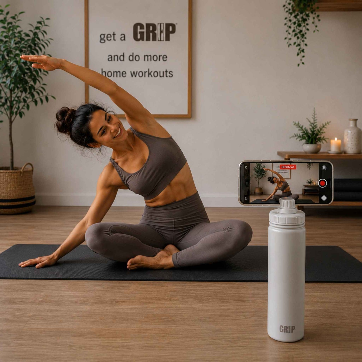 Taupe Phone Holder Water Bottle recording content creation for Pilates Instructor sat on mat in studio. 