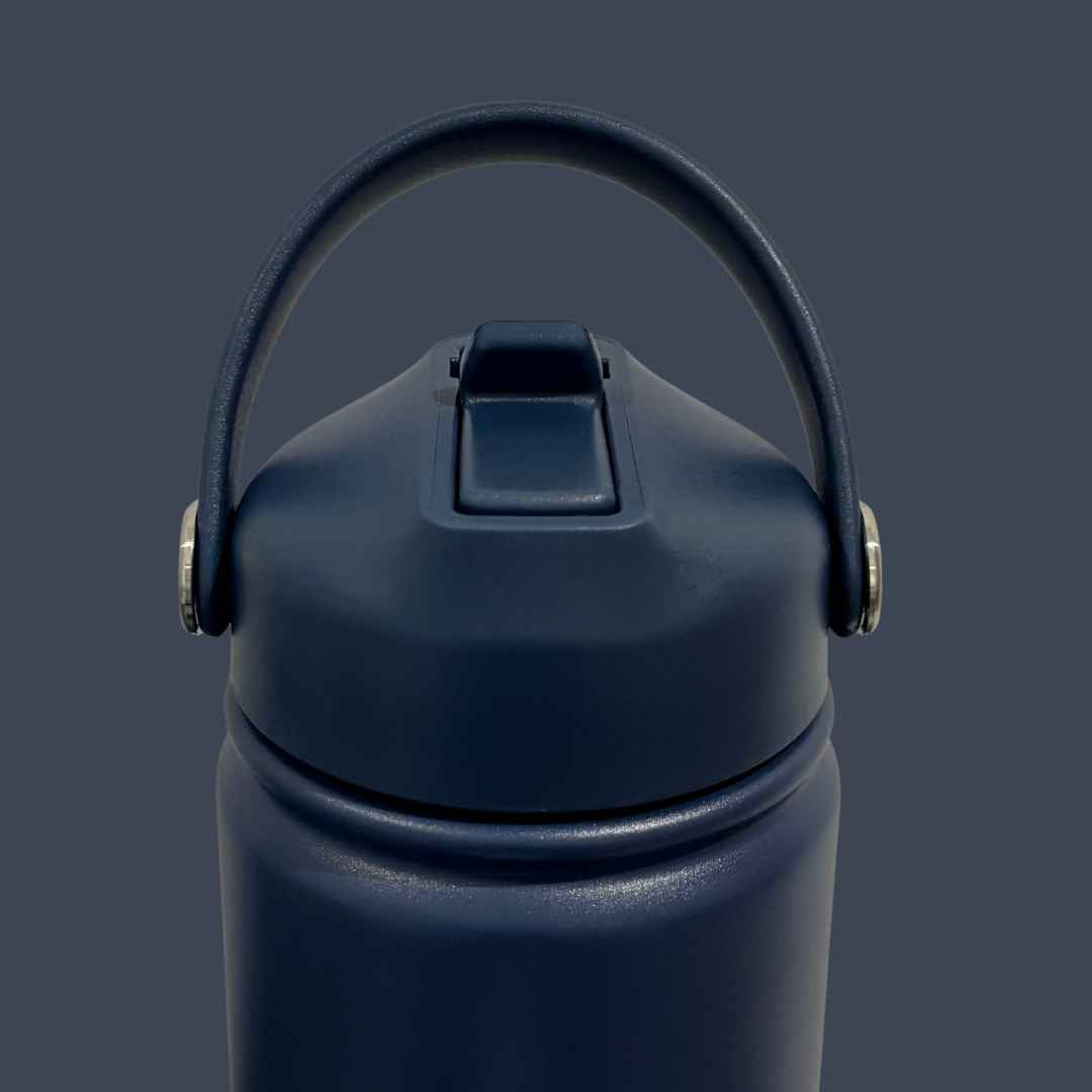 Kids water bottle easy-sip straw lid with handle up front view on navy blue Grip bottle 