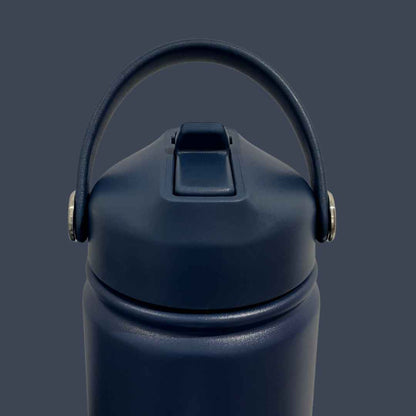 Kids water bottle easy-sip straw lid with handle up front view on navy blue Grip bottle 