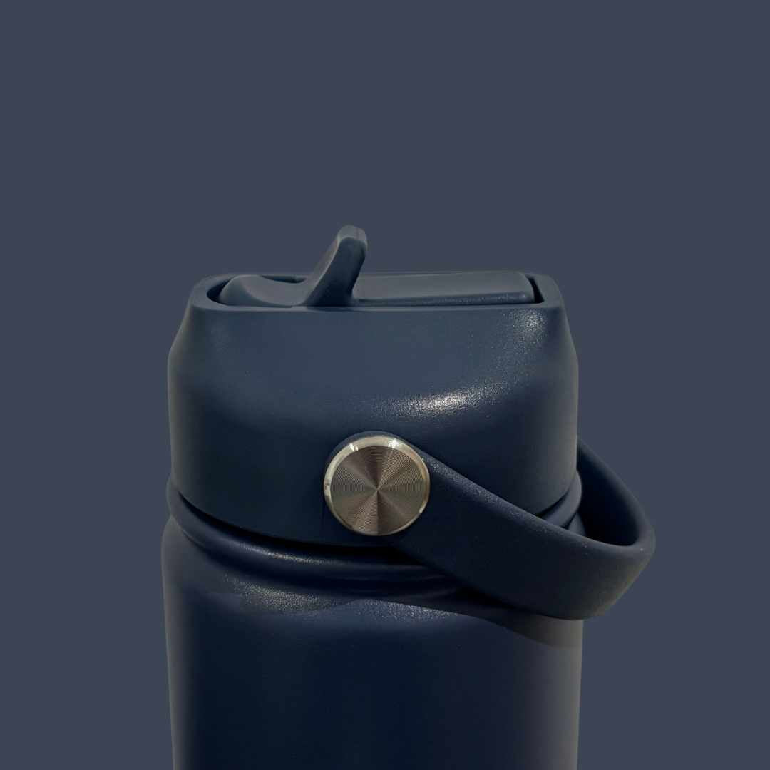 Kids water bottle easy-sip straw lid with handle down on navy blue Grip bottle 
