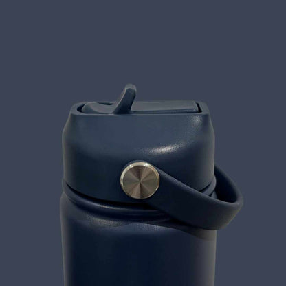 Kids water bottle easy-sip straw lid with handle down on navy blue Grip bottle 