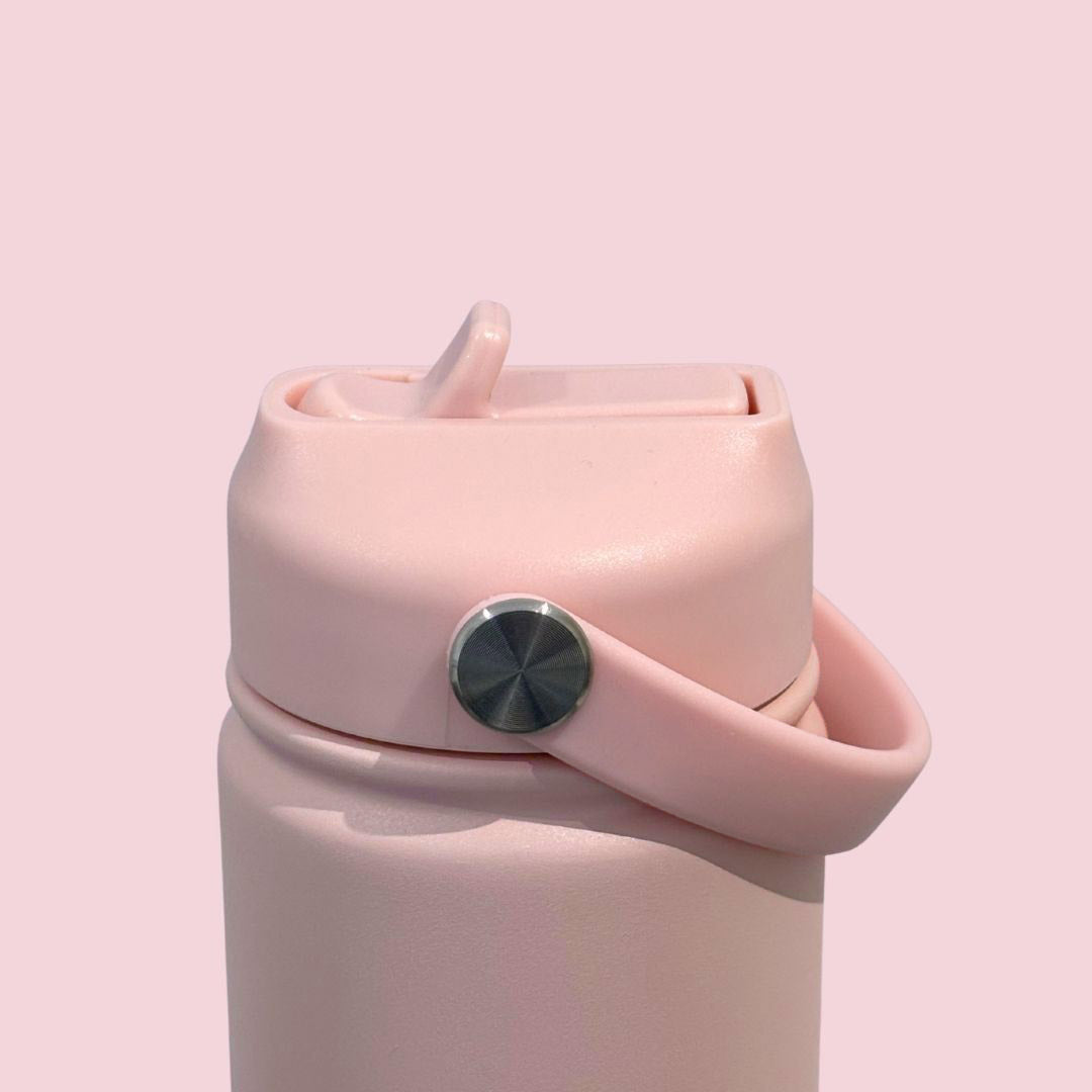 Kids water bottle easy-sip straw lid with handle down on baby pink Grip bottle 