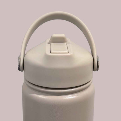Kids water bottle easy-sip straw lid with handle front view on taupe beige Grip bottle 